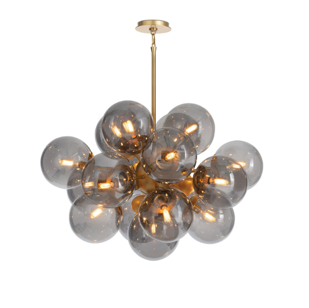 A chandelier with a cluster of smoky glass globes on brass arms, providing a mid-century modern look.
