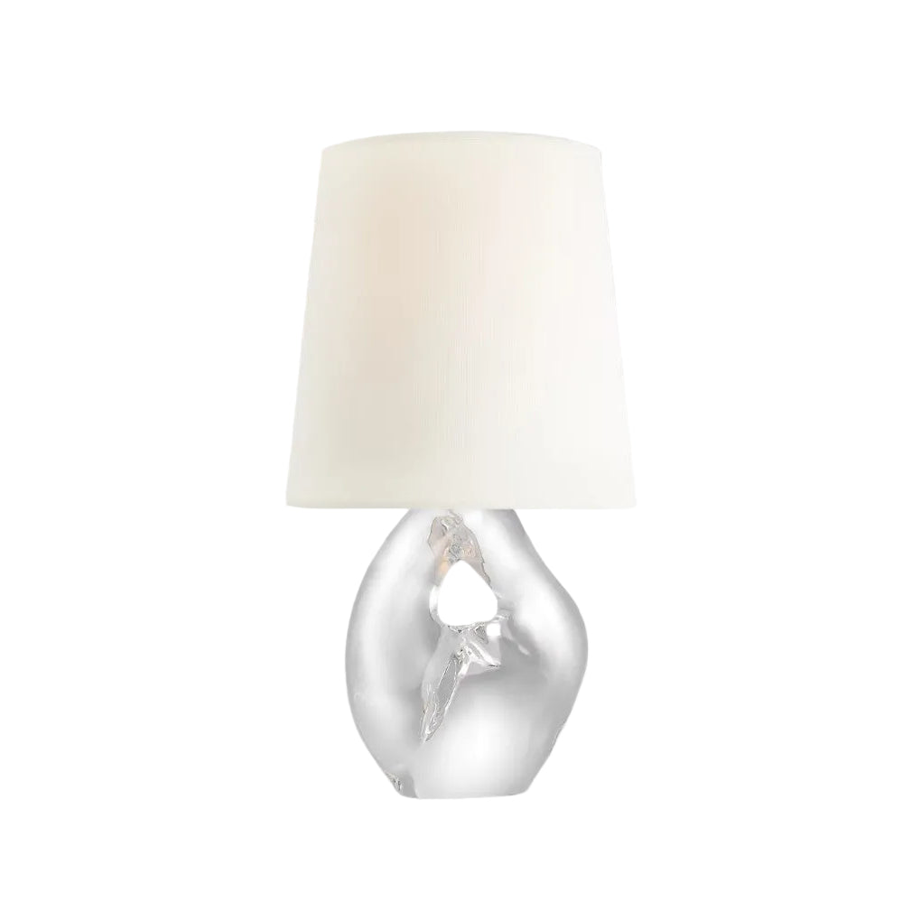 Table lamp with a white shade and silver base on a light gray background