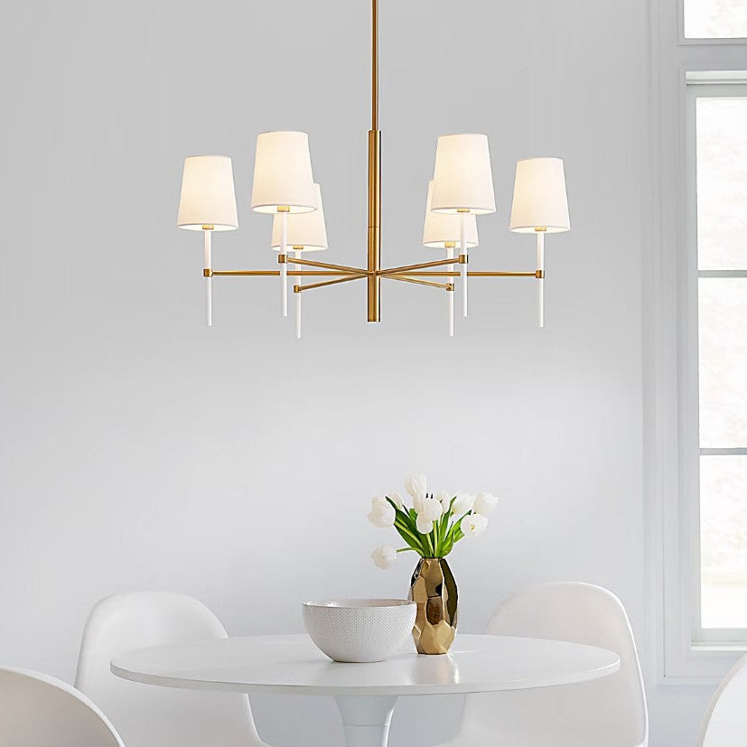 Modern chandelier with white lampshades in a dining room setting.