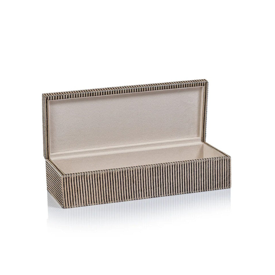 An open rectangular presentation box with a textured, vertically striped exterior in beige and brown tones and a smooth, light beige interior, shown on a white background with a soft reflection.