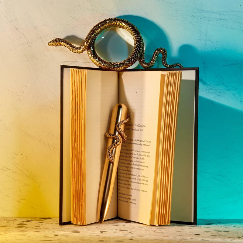 L'Objet Snake Magnifying Glass Large Gold angled view showing coiled serpentine handle and gold plated detail