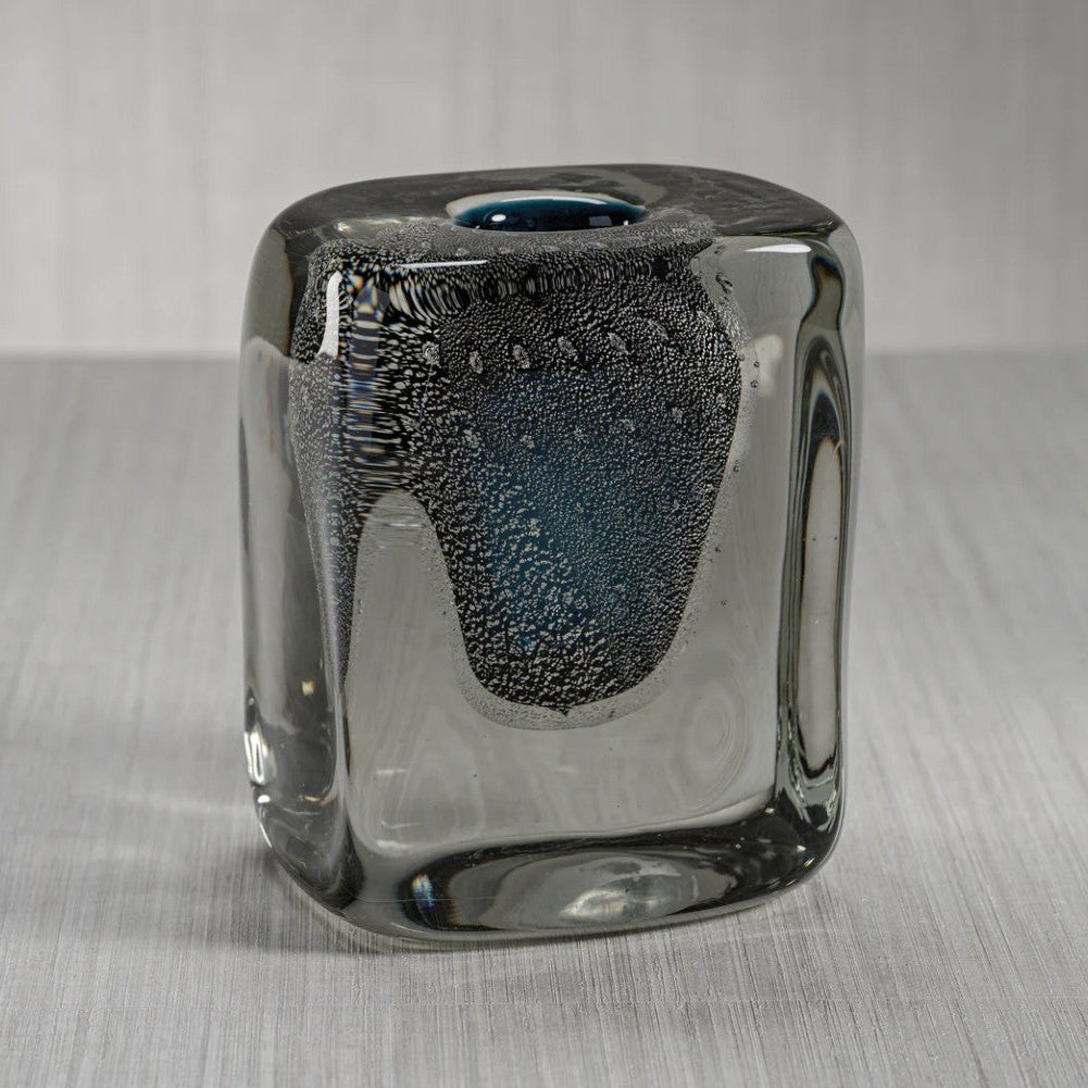 Glass vase with textured surface on a gray background